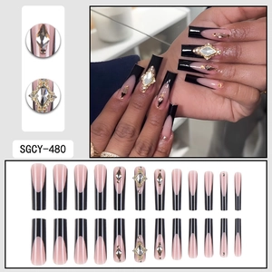 Long pink and black French press-on nails with luxury rhinestones and gold accents