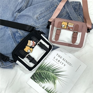 Detail of canvas crossbody bags with cute cartoon patches and PU leather strap closure
