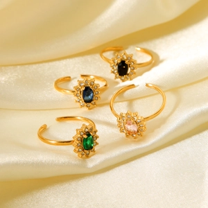 Adjustable gold plated rings with colorful zircon stones on elegant champagne satin fabric