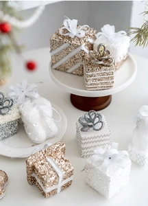 Detail of glittery champagne gold and white Christmas gift box and boot ornaments