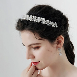 Detail of white flower and pearl headband set with matching teardrop earrings for girls