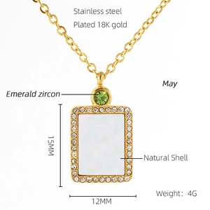 Detail view of 18K gold plated stainless steel necklace with emerald zircon and shell