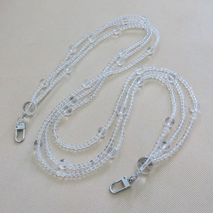 Macro detail of transparent beaded chain strap with polished silver lobster clasps