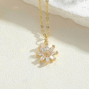 Detailed macro view of golden sunflower pendant necklace with inlaid white zircon crystals
