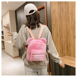 Rear view of a soft pink plush backpack with cute bear ears and golden zippers