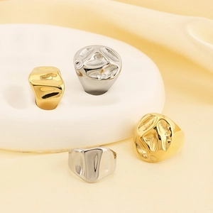 Irregular textured metal rings in gold and silver finish with lava style design
