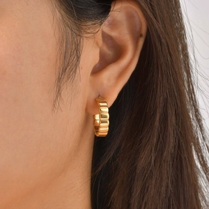 Minimalist double layer gold hoop earrings with ribbed texture on female model