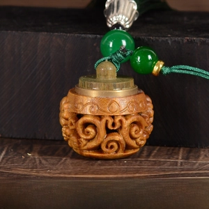 Macro detail of hand-carved sandalwood lantern charm with size measuring 28x27mm