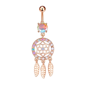Macro detail of rose gold dreamcatcher belly ring with zircon stones and leaf pendants