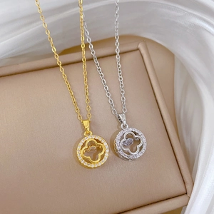 Sparkling four leaf clover pendant necklace in gold and silver with zircon accents