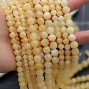 Detail of natural cream yellow stone beads for DIY jewelry making in various sizes