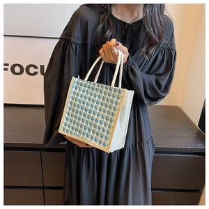 Detail of a square blue and white checkered jute tote bag with white rope handles