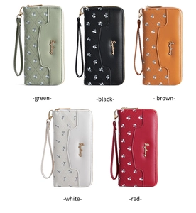 Long zip-around wallets with wristlet straps in five colors and floral embossed patterns