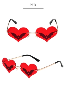 Detailed views of red heart-shaped bat sunglasses with golden metal temples and accents