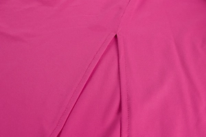 Macro shot of precise slit stitching and woven texture on a deep pink elegant dress