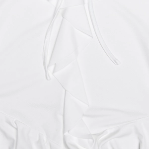 Close-up of white knitted dress detail featuring drawstring and ruffled hem textures