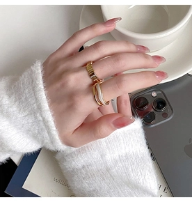 Gold geometric wide ring and layered white band worn with cozy French chic styling