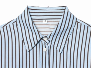 Detail shot of the neckline and placket on a blue and brown striped poplin shirt