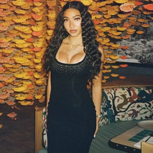 Close-up of square neck black bodycon dress with sparkling rhinestone neckline detail