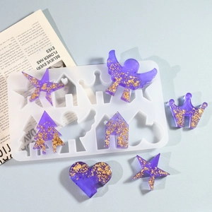 DIY silicone mold for resin craft featuring angel, house, and star shapes with gold foil