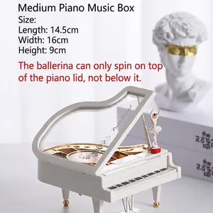 Detailed view of white piano music box with rotating ballerina doll and open lid detail