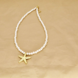 Beaded pearl necklace with a gold starfish pendant featuring an adjustable lobster clasp