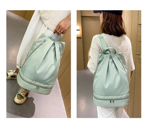 Detail view of light green oxford swim bag with separate dry wet compartment and shoe storage