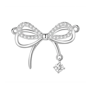 Detailed view of silver bow-shaped pendant with cubic zirconia and a large crystal drop