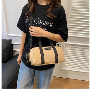 Khaki nylon Boston bag detail with black wide strap and small pouch attachment