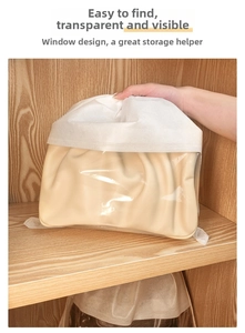 Close-up of clear PVC window on non-woven dust bag showing the golden handbag inside