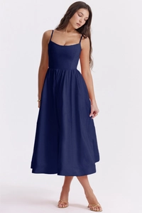 Detail view of navy blue backless sundress featuring thin straps and waist-cinching cut