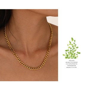 Close-up of gold plated stainless steel Cuban link necklace with flat chain design