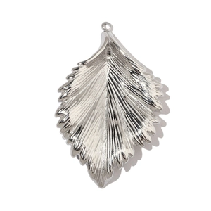 Macro detail of silver stainless steel leaf pendant showing intricate vein texture