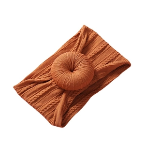 Soft nylon infant headband in orange knit fabric with a large central doughnut knot