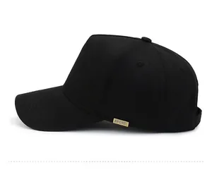 Side view of black cotton baseball cap showing the gold metal Sport logo plaque