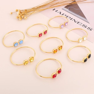 Top view of gold-plated square open bracelets with multicolored faceted gemstones