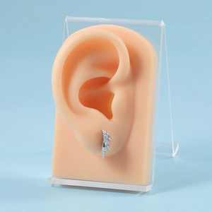 Detail showing elegant silver earrings with three rectangle blue cubic zirconia on ear model