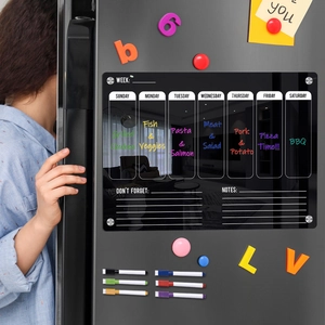Black magnetic acrylic weekly planner on a dark fridge with 6 colored dry erase markers