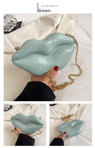 Detail view of mint green lip-shaped acrylic box bag with golden chain strap
