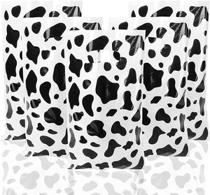 Detail of stacked plastic gift bags with cow print pattern and die-cut handles