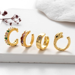 Set of four gold ear cuffs with colorful zircon stones, snake design, and evil eye motif