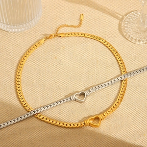 Minimalist 18K gold and silver plated stainless steel heart necklaces on beige fabric