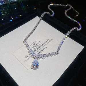 Detailed view of luxury silver water drop zircon pendant necklace on velvet box