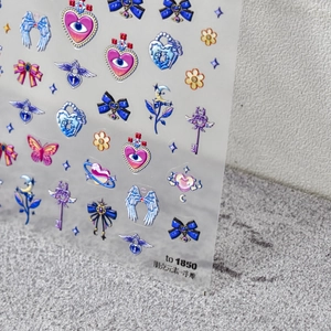 Macro shot of 5D embossed punk nail stickers featuring heart, wing, and moon motifs