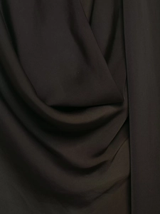 Close-up of dark satin fabric showing smooth texture and elegant drape details