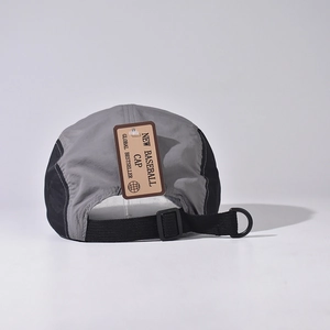 Detail of the 5-panel baseball cap showing the black strap buckle and D-ring attachment