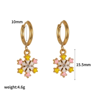 Detail showing dimensions and weight of golden enamel snowflake hoop earrings