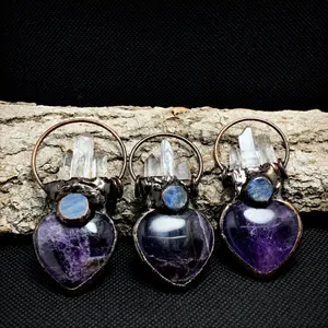 Detail of vintage heart amethyst pendant with crystal points and antique bronze wrap