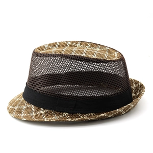 Detail of breathable dark brown mesh and woven straw texture on the men's fedora hat
