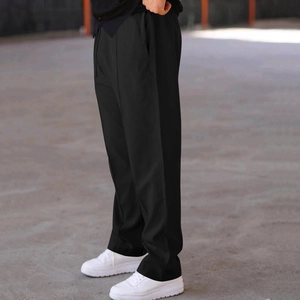 Detail view showing the drape and relaxed fit of black wide-leg street style casual pants